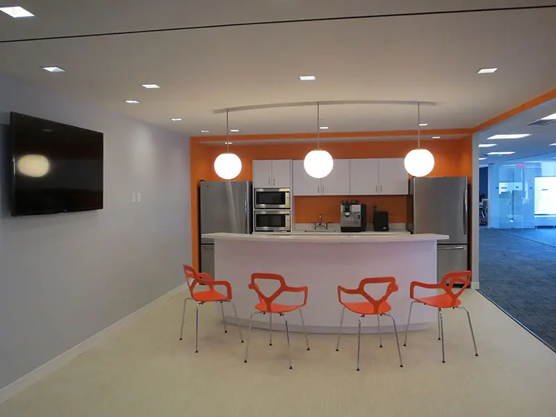 TransPerfect pantry with pendant lights and bar stools